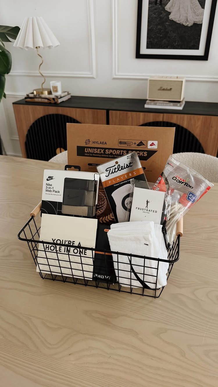 Golf gift basket with Titleist balls, white towels, and a hole-in-one card.