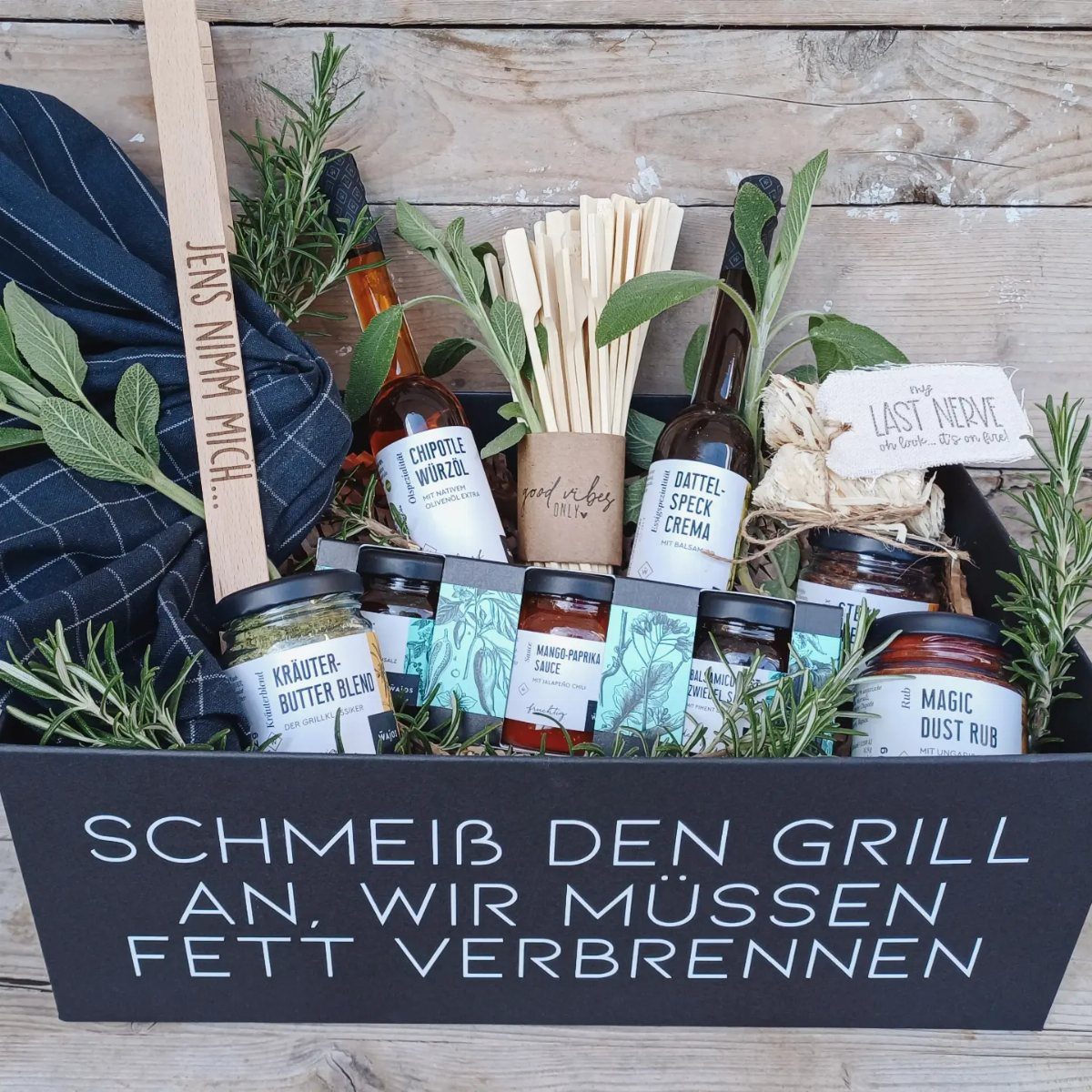 Grilling gift basket with sauces, rubs, and herbs in a black box