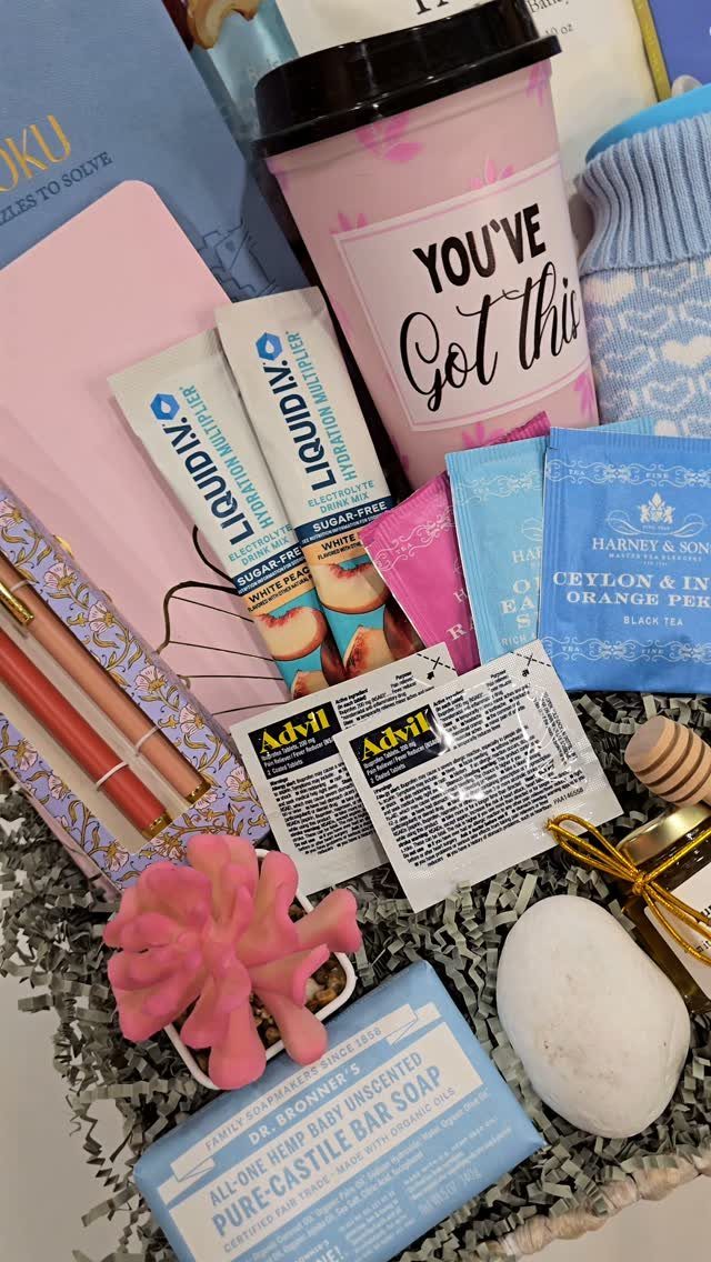 Gift basket with pink tumbler, wellness products, and a small succulent for comfort.