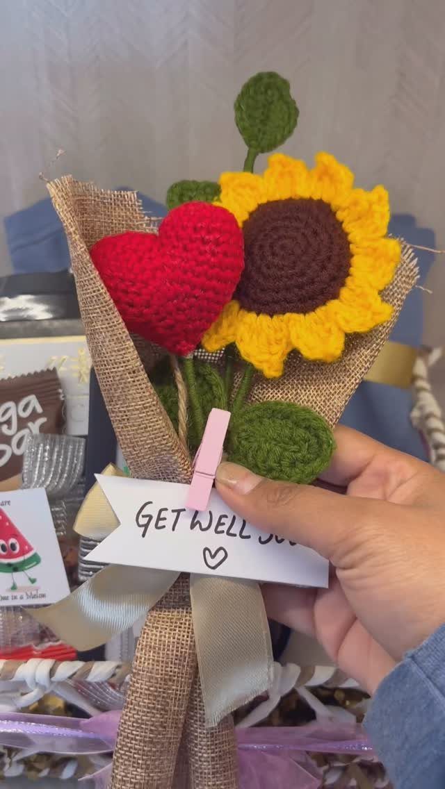 Crocheted sunflower and red heart bouquet with a handwritten get well card.