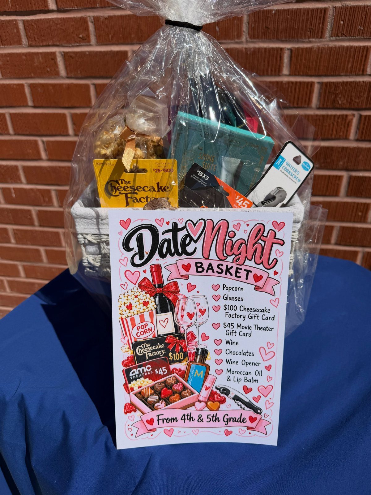Date Night gift basket wrapped in cellophane with a detailed contents list sign.