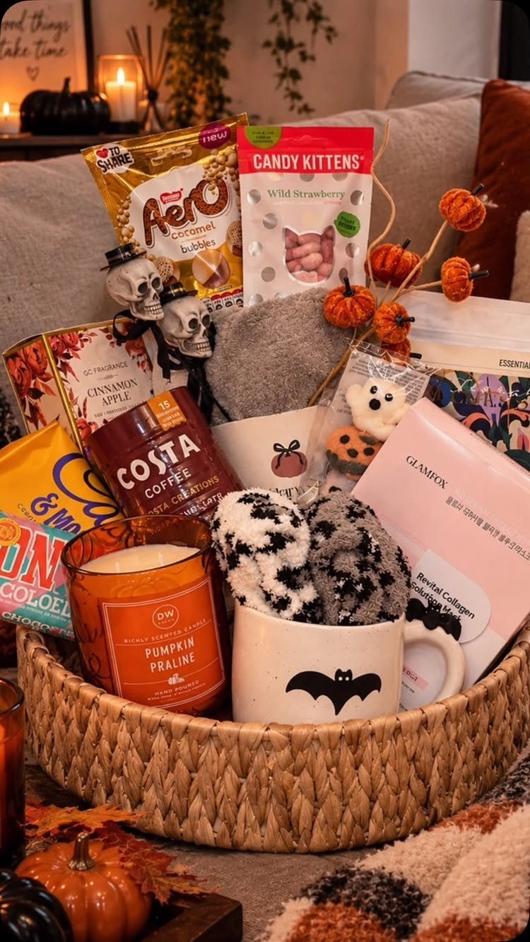 Woven gift basket filled with Halloween treats, candles, and spooky decorations for a raffle.