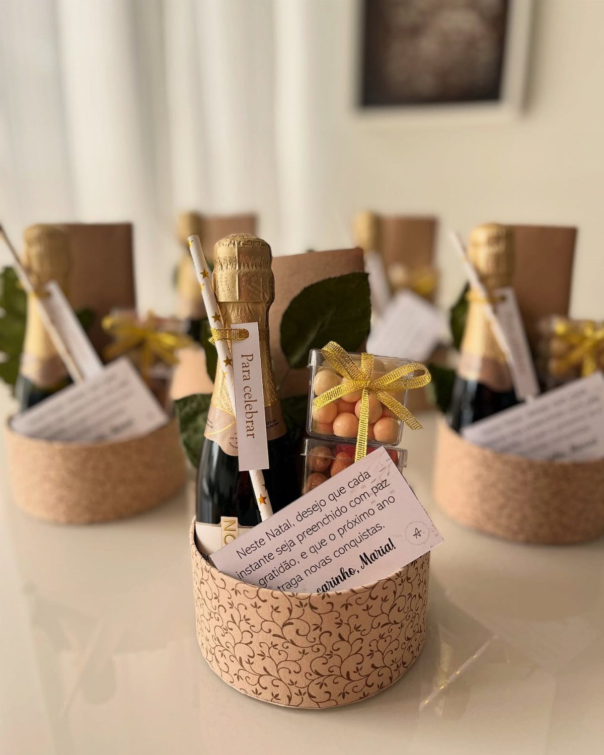 Mini champagne bottles and yellow candies in small patterned gift baskets with notes.