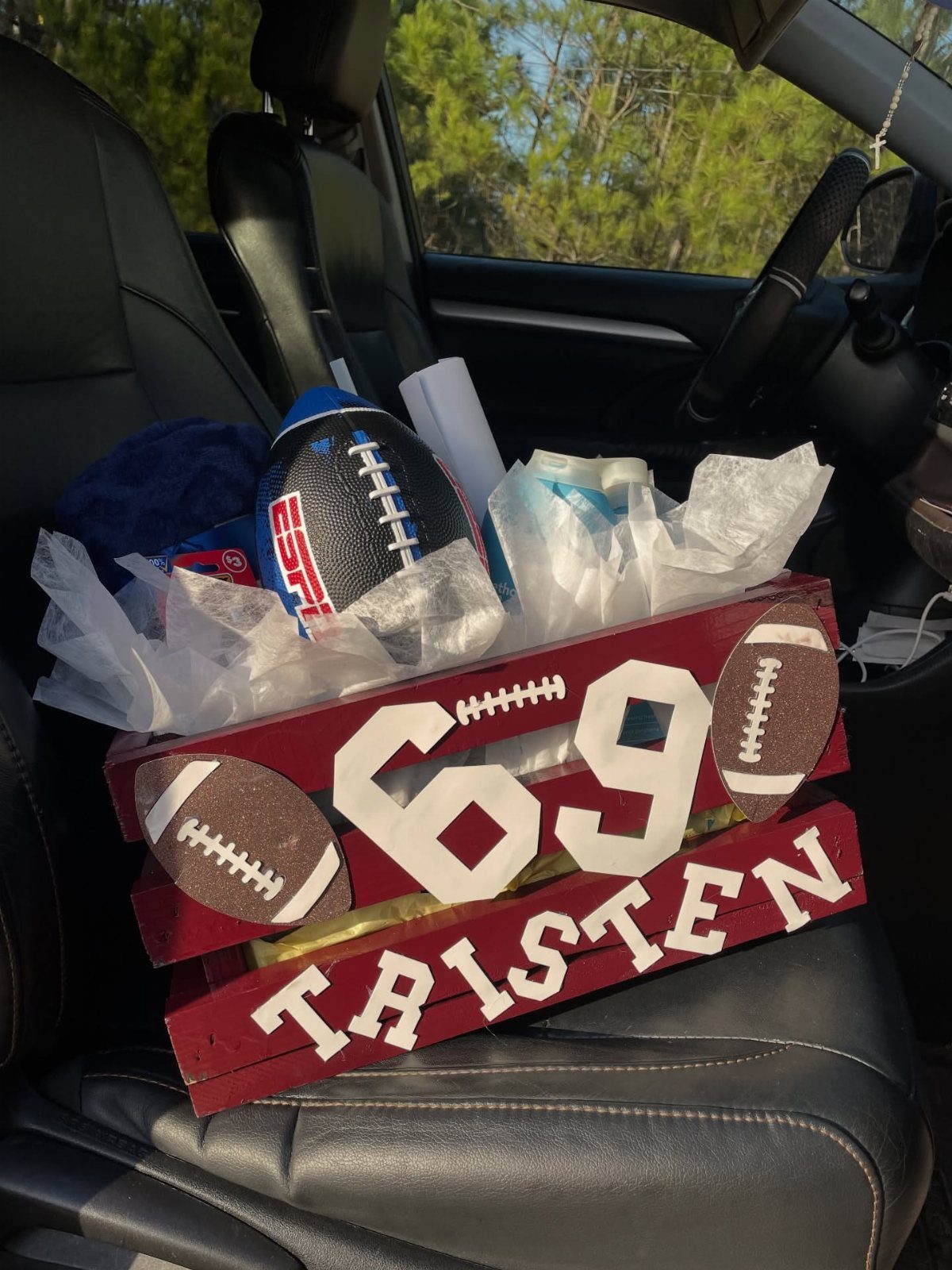 Sports themed gift crate with football and personalized name on car seat