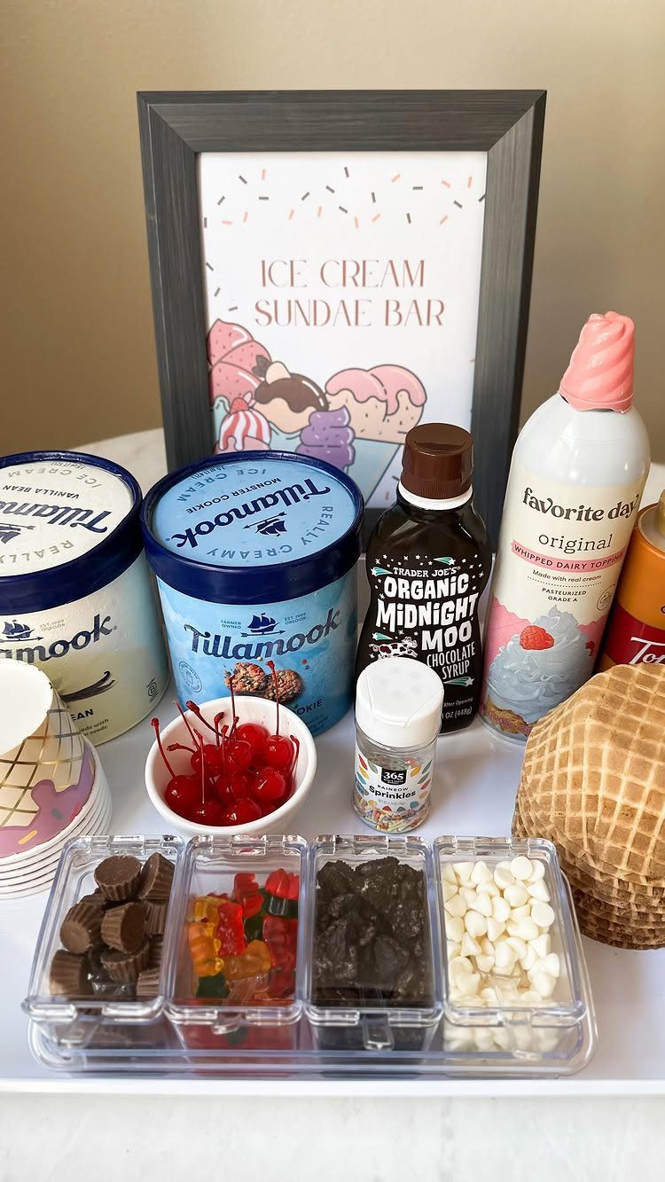 Ice cream sundae kit with ice cream, syrups, toppings, and waffle cones.