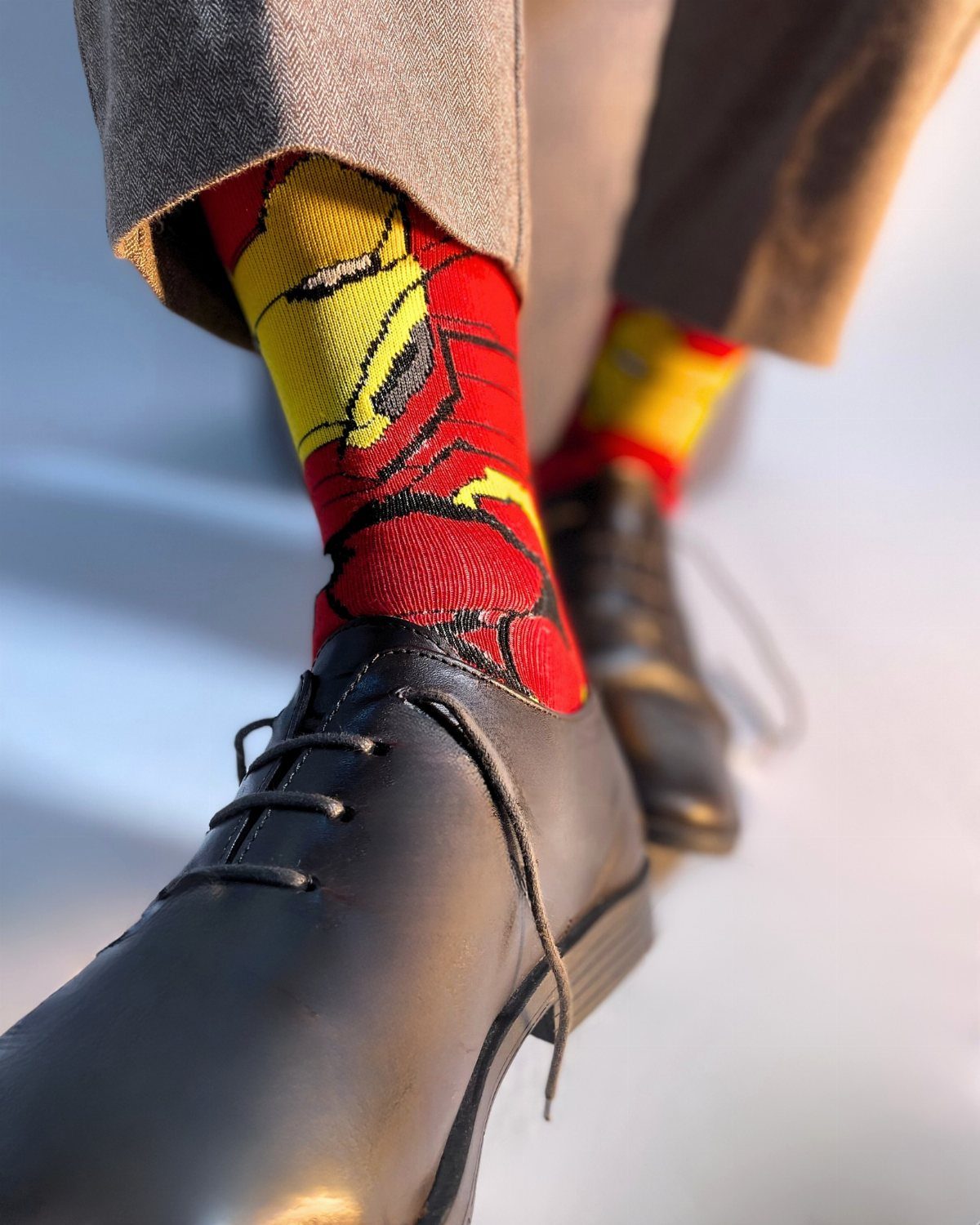 Iron Man themed red and yellow socks worn with black dress shoes.