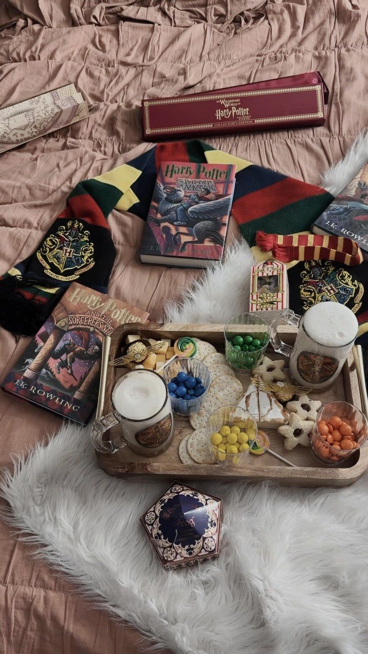 Harry Potter themed snacks and books arranged on a wooden tray and faux fur.