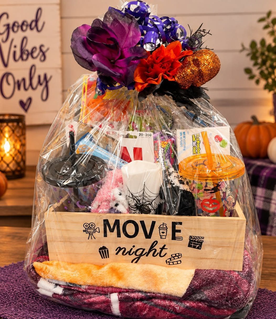 Movie night gift basket in a wooden crate with snacks and colorful decorations.