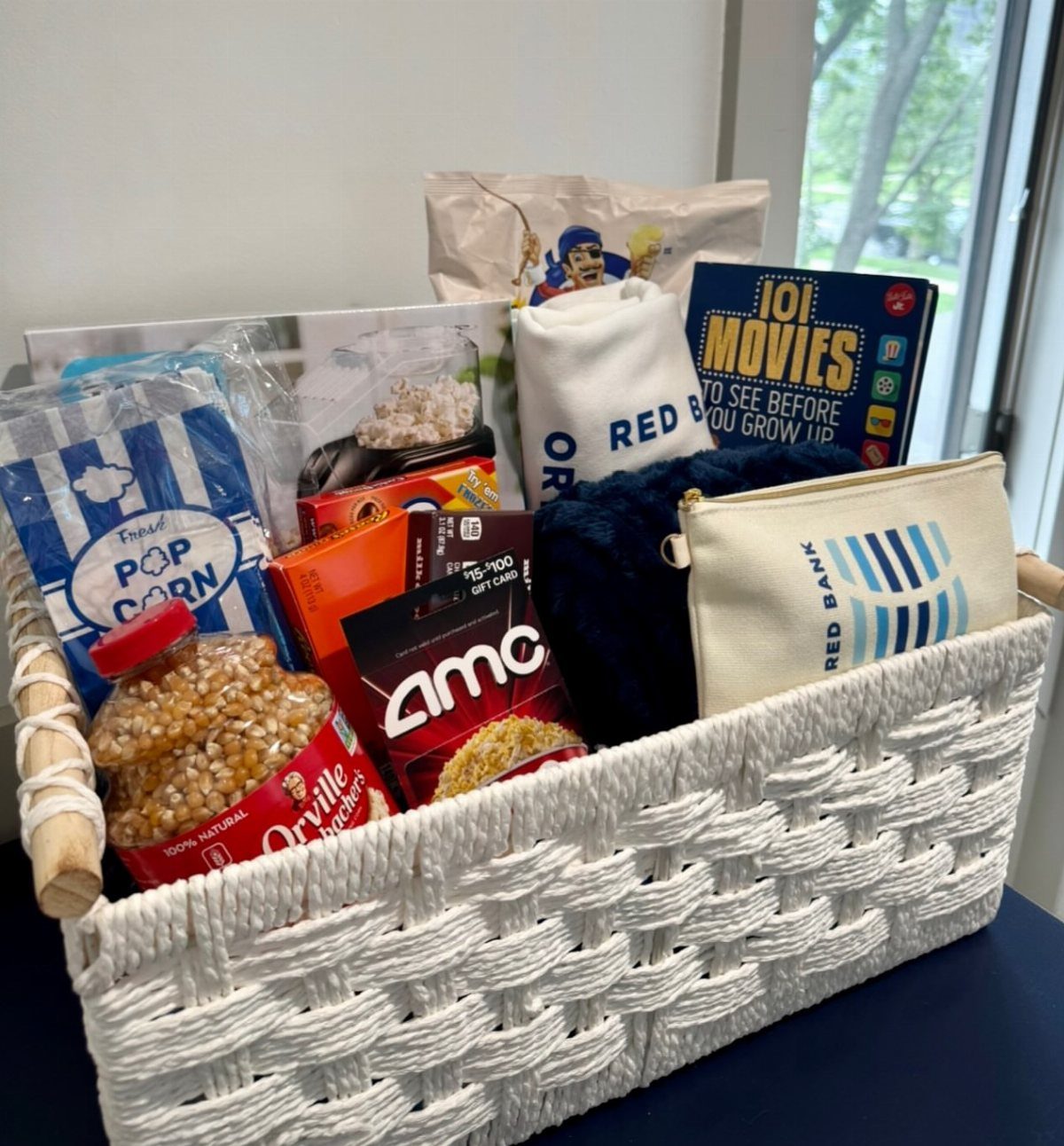 Movie themed gift basket with popcorn, AMC gift card, and cinema book
