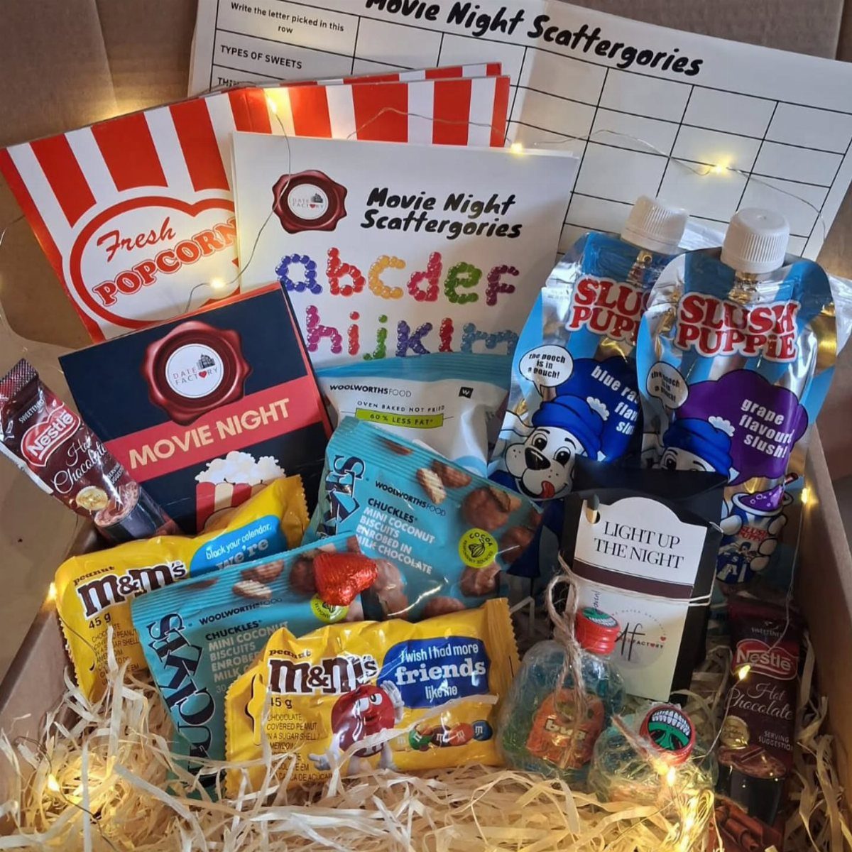 Movie night gift box filled with snacks, drinks, and a trivia game.