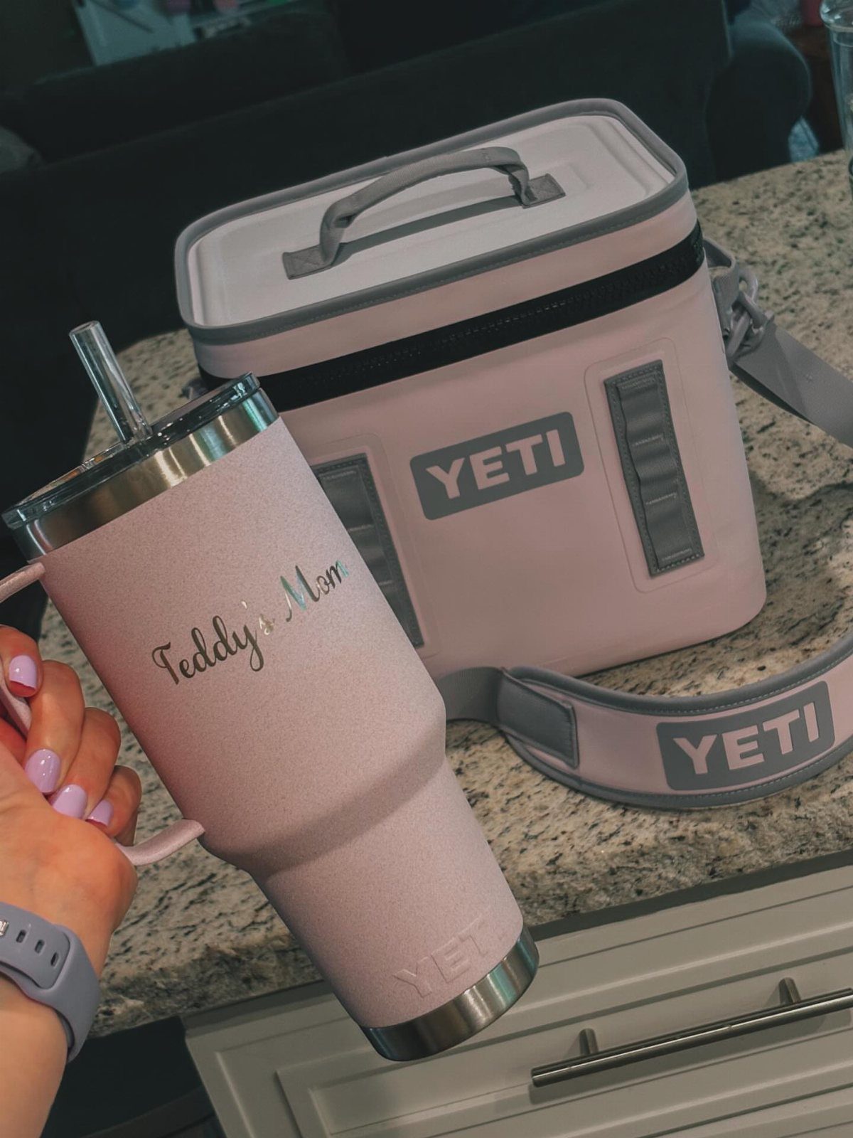 Pink Yeti thermal tumbler and matching cooler bag on a granite kitchen counter