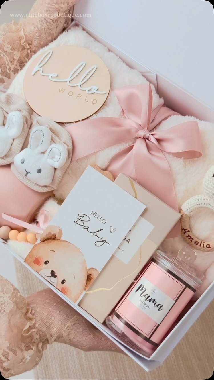Gift box with baby booties, plush blanket, and a Mama candle for new parents.
