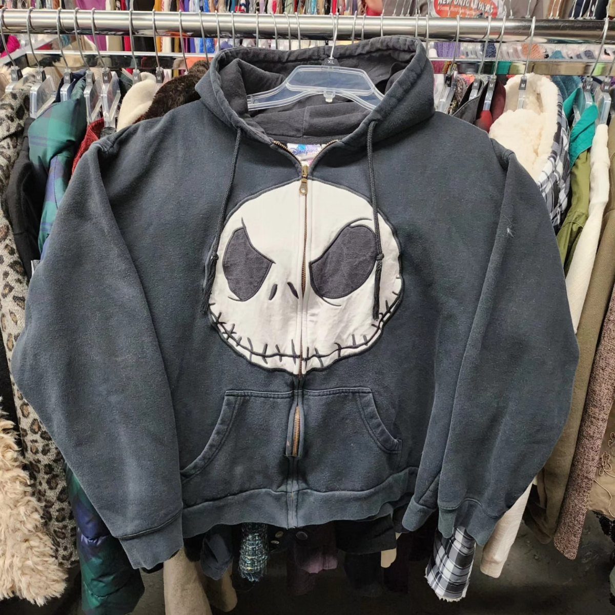 Dark grey zip-up hoodie featuring a large Jack Skellington skull graphic on front.