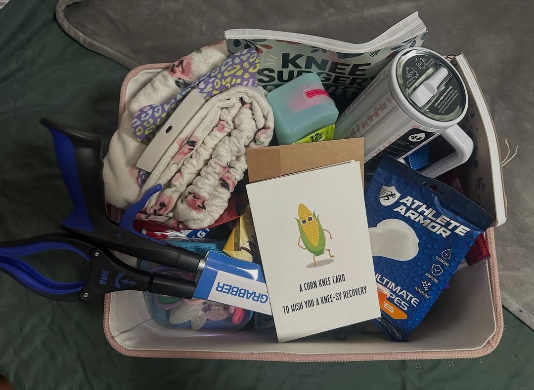 Recovery gift basket containing a grabber tool, knee surgery magazine, and care items.