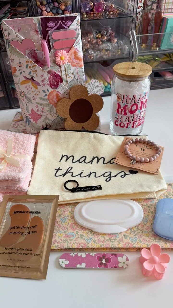 Postpartum care kit with mama things pouch, floral bag, and pink accessories.