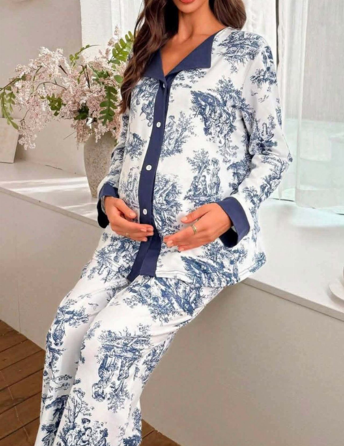 Pregnant woman wearing blue and white toile de jouy patterned soft pajamas.