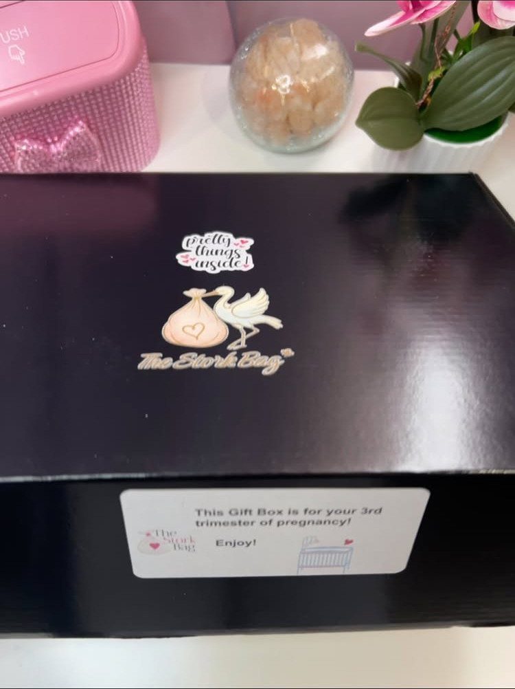 Black pregnancy gift box with a 3rd trimester card and stork logo.