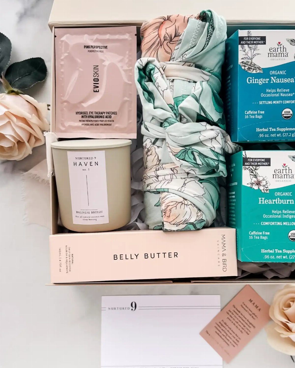 Gift box with floral wrap, belly butter, candle, and organic pregnancy teas.