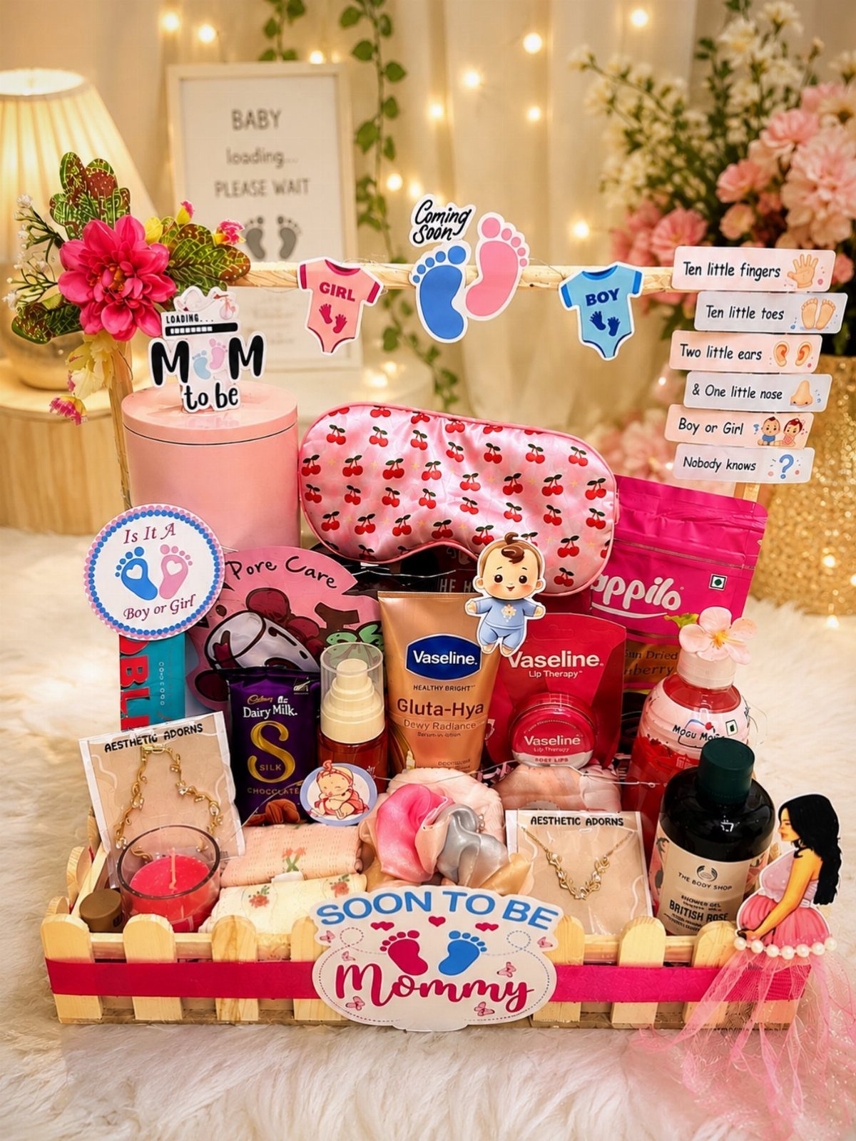 Pregnancy gift basket with skincare, sleep mask, and jewelry in a wooden fence tray.