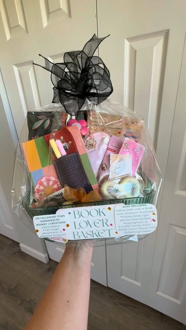 Book lover gift basket wrapped in cellophane with a black bow and label.