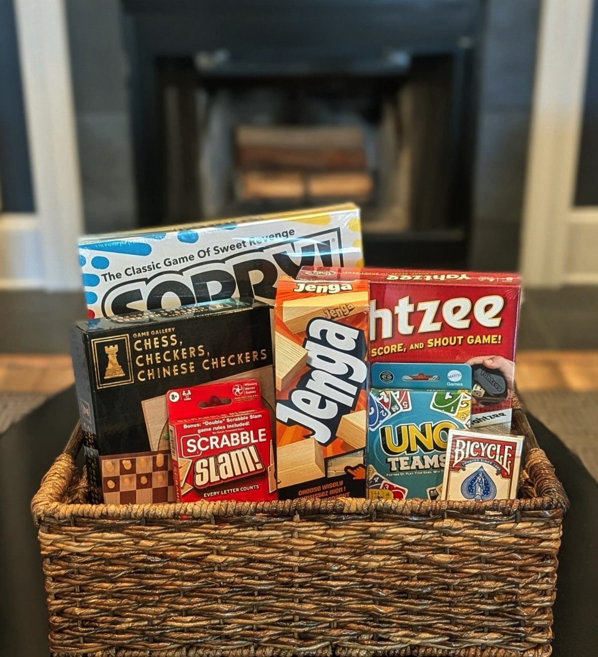 Woven wicker basket filled with various board games for a family game night.