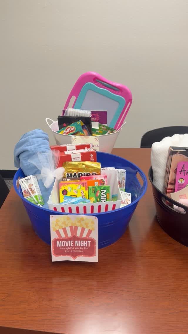 Blue tub filled with movie snacks and a blanket for a raffle basket
