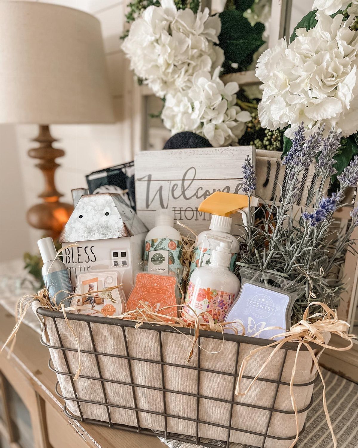 Wire basket filled with home decor, soaps, and lavender for a silent auction.