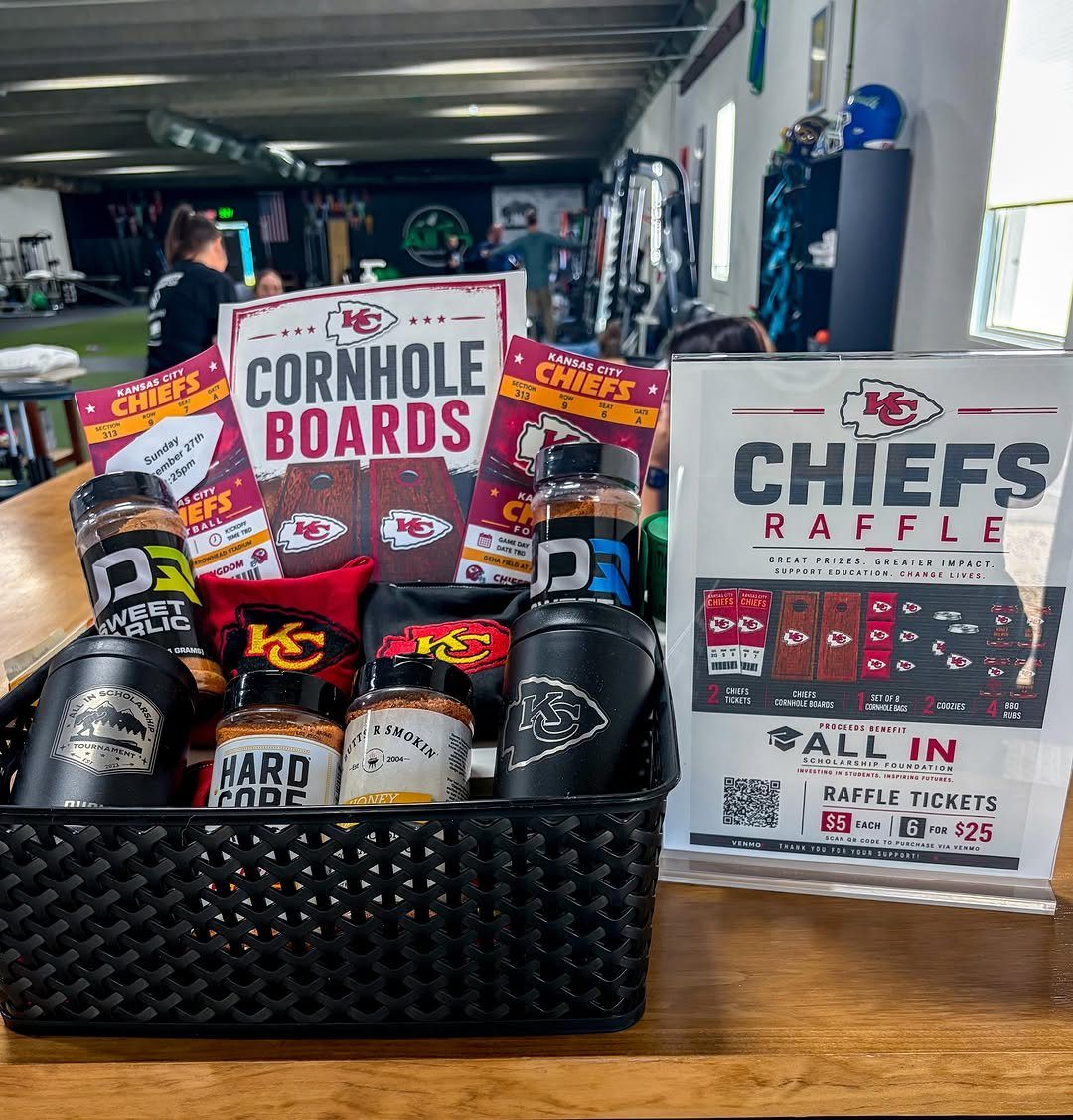 Kansas City Chiefs themed raffle basket with spice rubs and team merchandise.