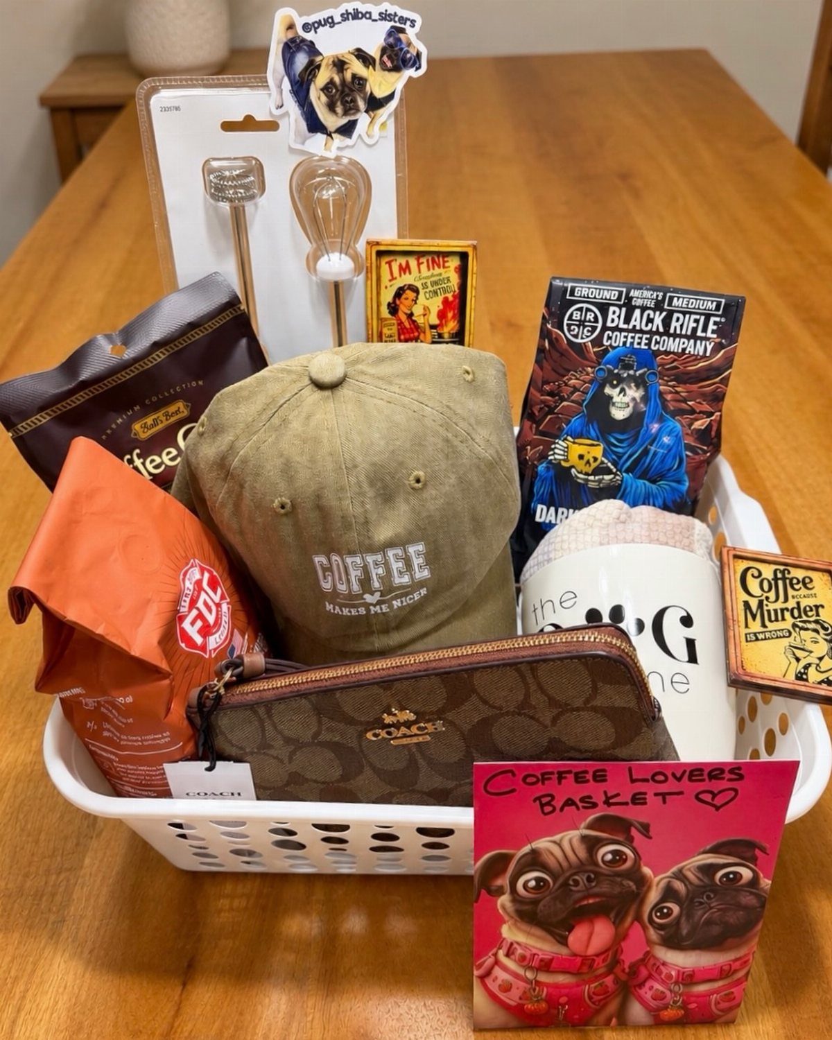 Coffee lovers gift basket with coffee bags, a tan cap, and a mug.