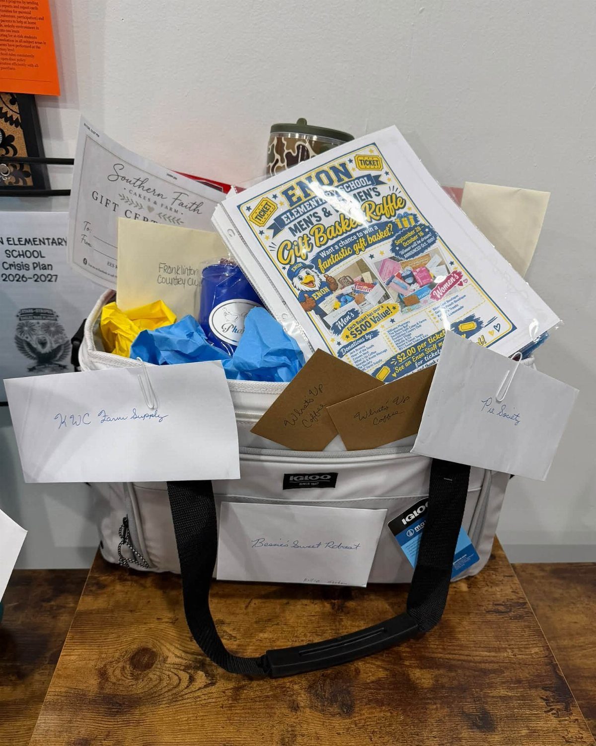 White cooler bag raffle basket for men containing a gift certificate and flyer.