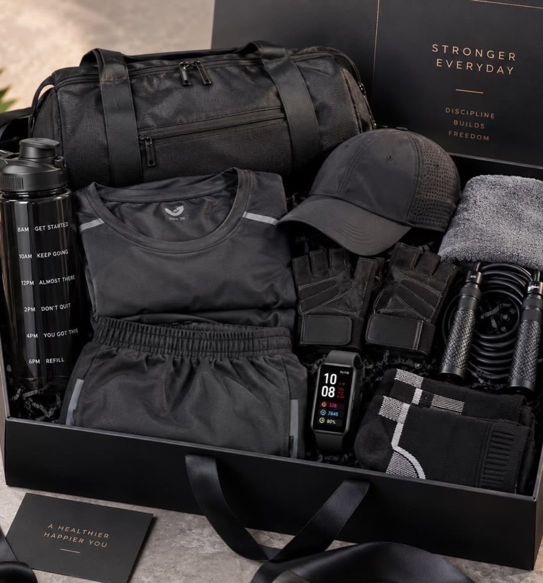 Fitness gift set in a black box with gym clothes, bag, and accessories.