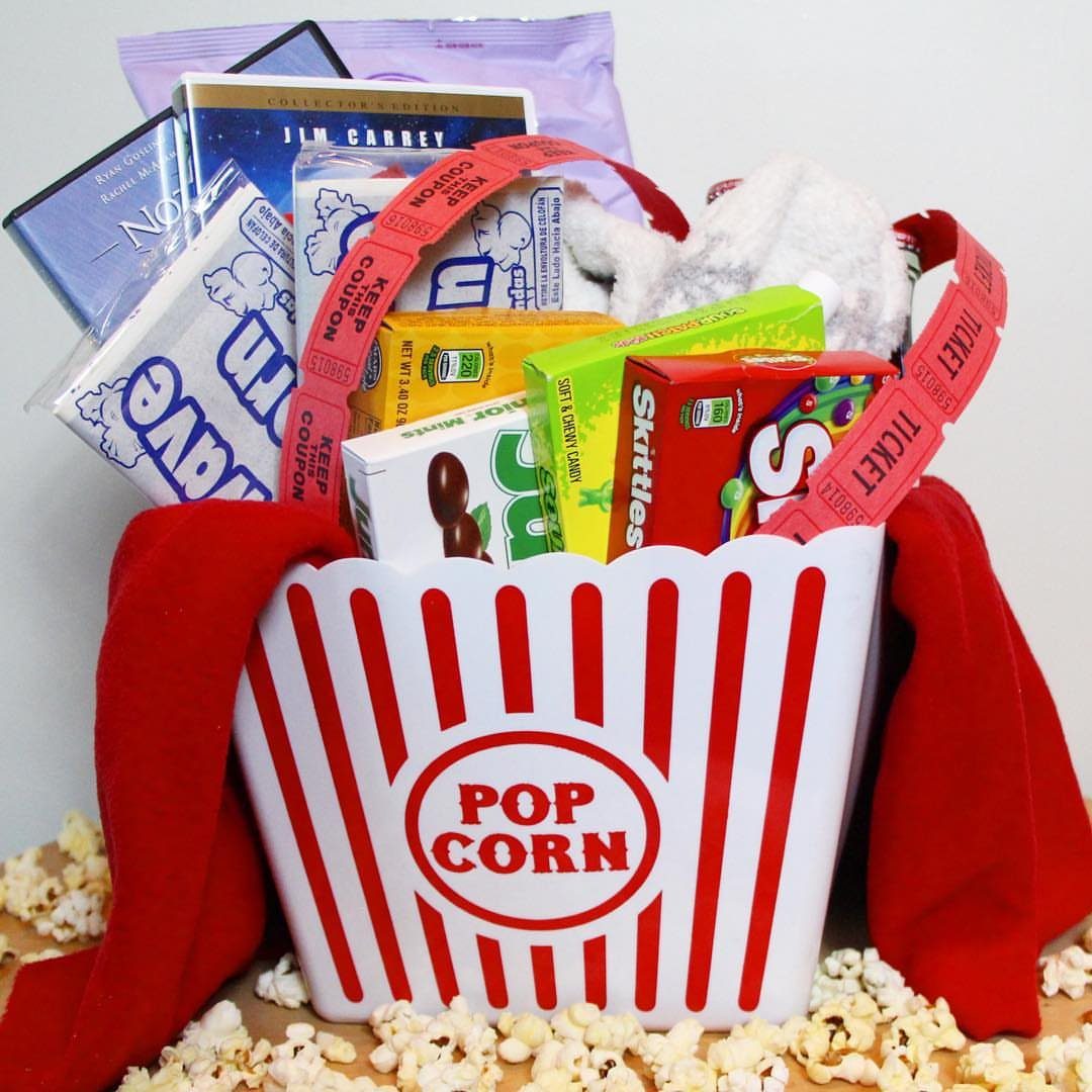 Popcorn bucket gift basket filled with movie theater candy and a DVD.