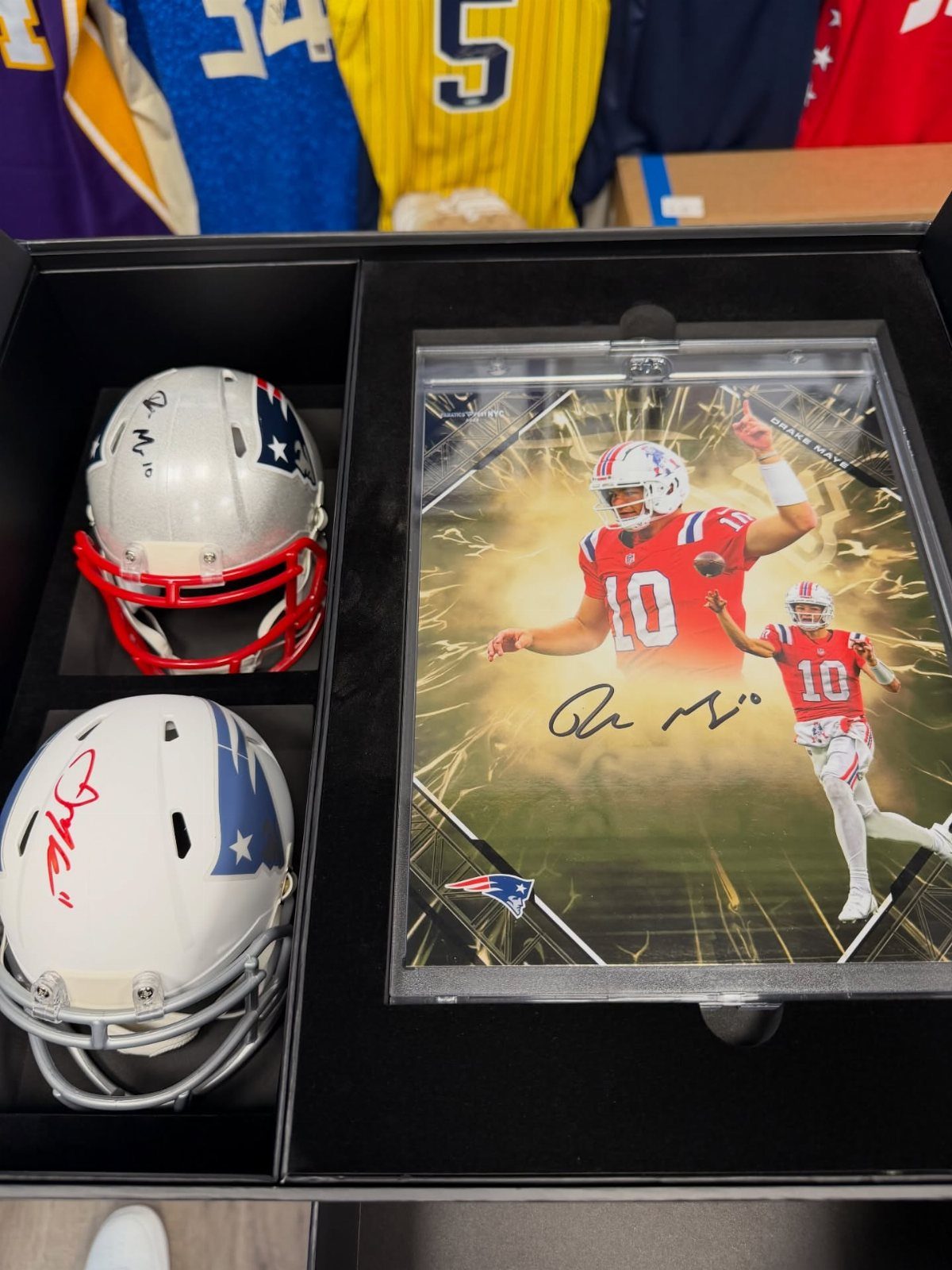 Football themed gift set with two helmets and a signed player photograph