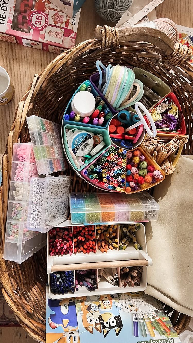 Woven basket filled with colorful beads, markers, pipe cleaners, and various craft supplies.