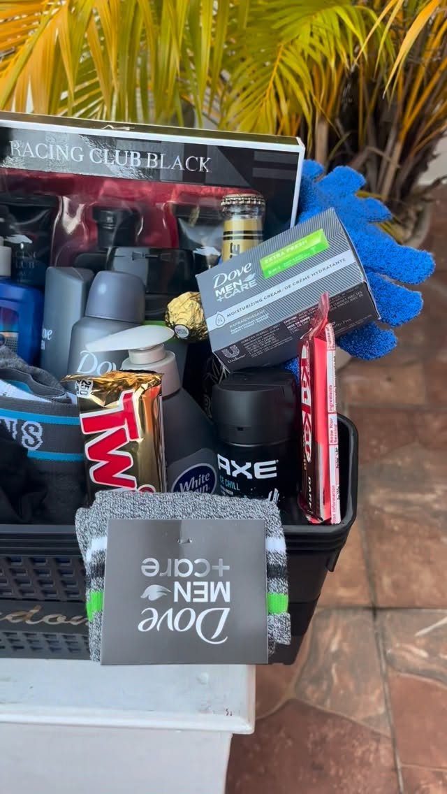 Black basket filled with Dove and Axe grooming products and a Twix bar.