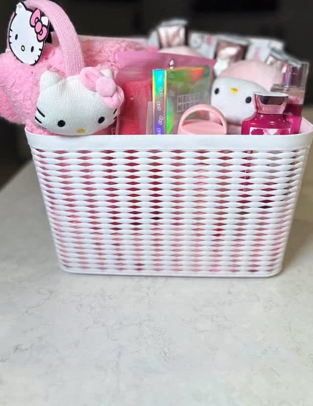 White woven basket filled with pink Hello Kitty plushies and beauty care products.