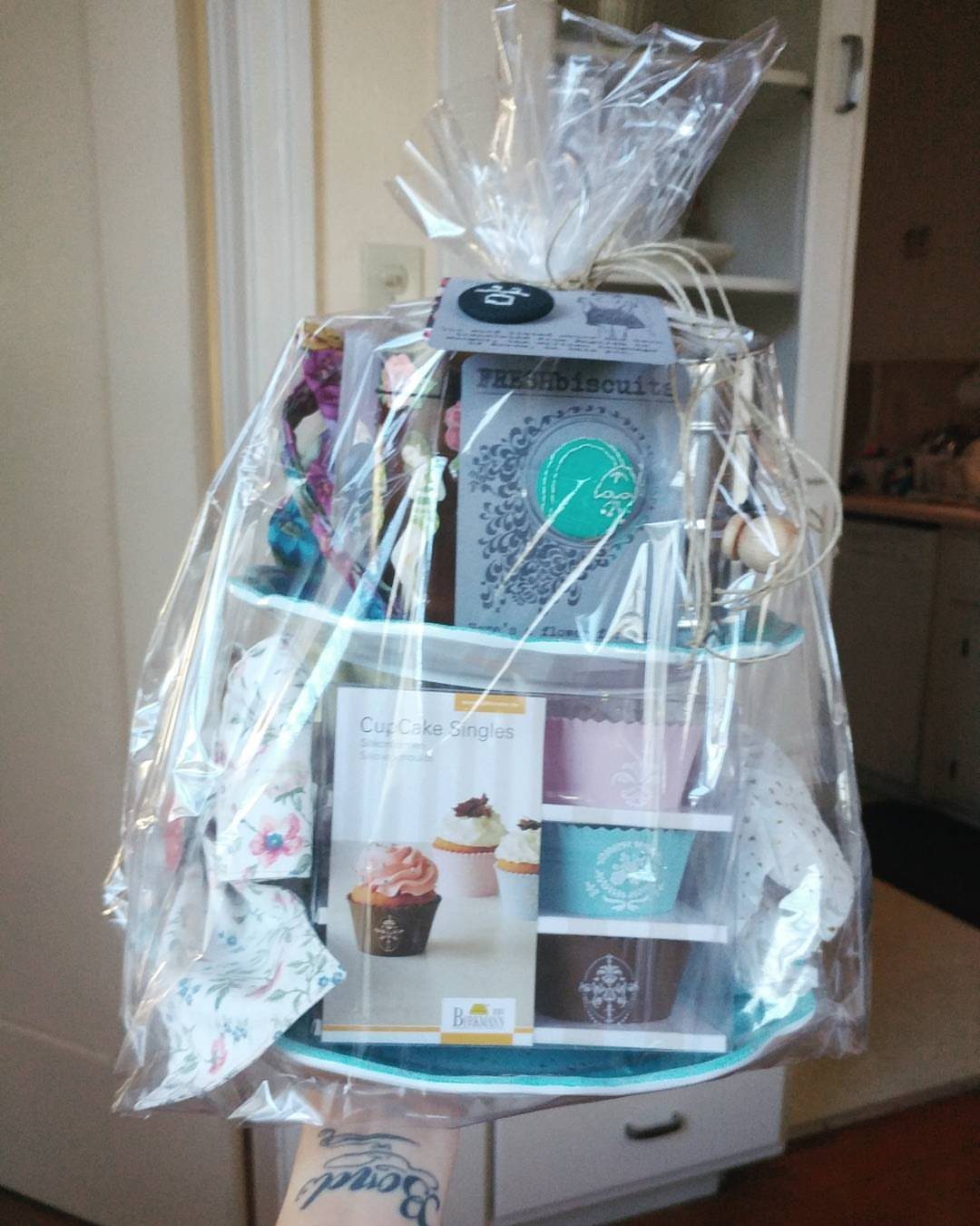 Baking gift set with cupcake liners and supplies wrapped in clear cellophane.
