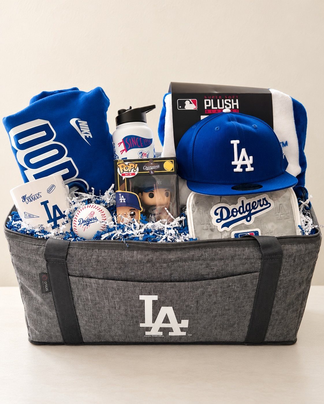 Los Angeles Dodgers themed gift basket with blue apparel, baseball, and accessories.