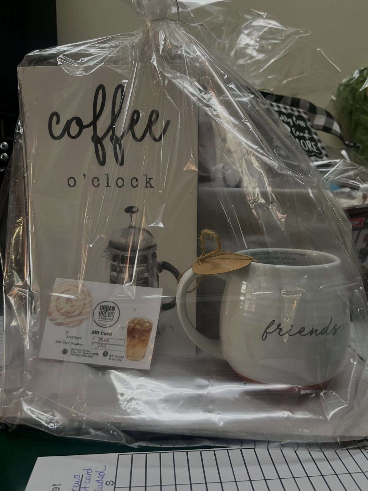Coffee gift basket with a white friends mug and coffee o'clock sign.