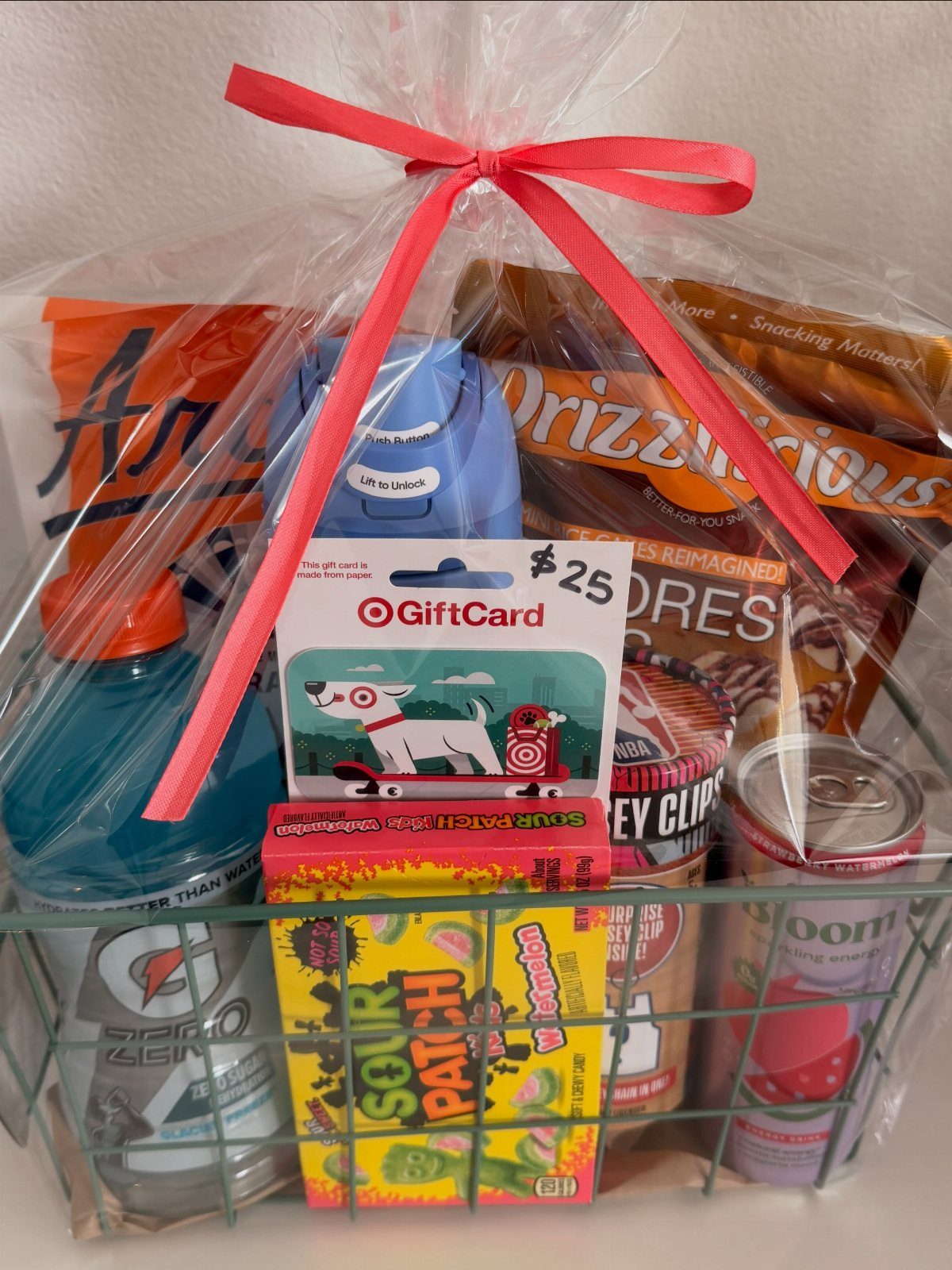 Gift basket wrapped in cellophane with snacks, candy, and a Target gift card.