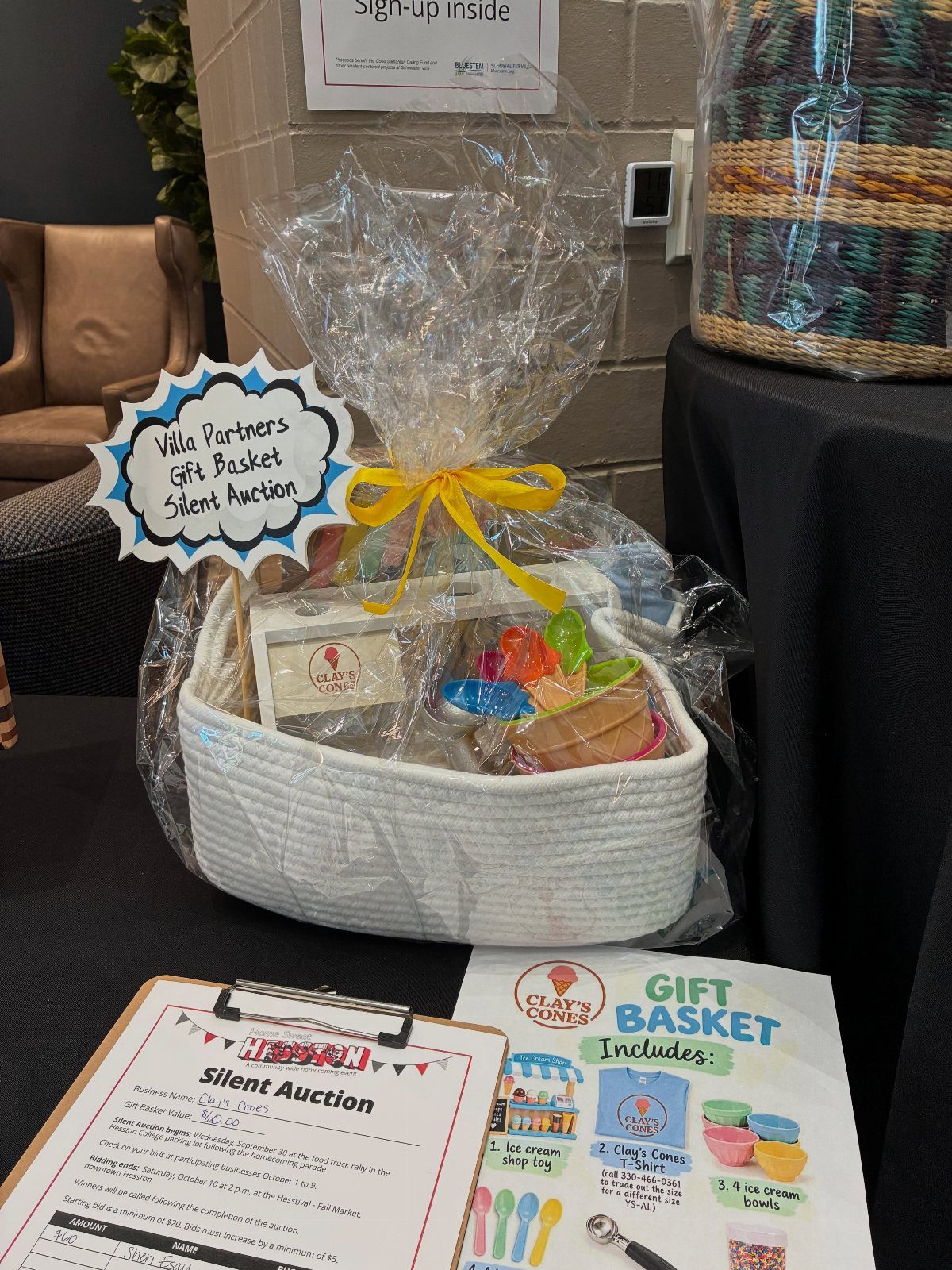 White woven gift basket with ice cream supplies for a silent auction.
