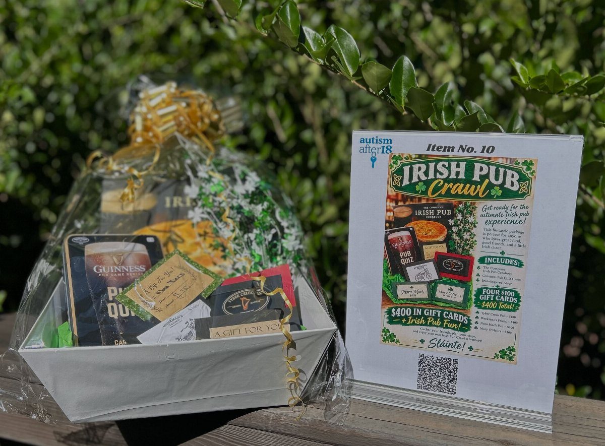 Irish Pub Crawl gift basket wrapped in cellophane with a descriptive auction sign.