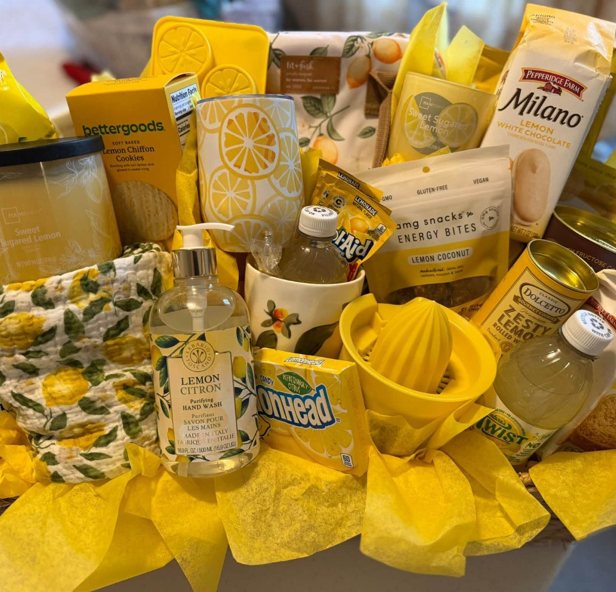 Yellow themed gift basket containing lemon cookies, soap, and a citrus juicer.