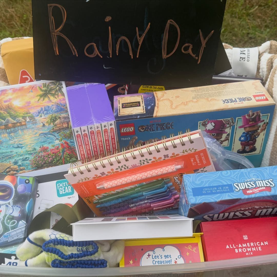 Rainy Day gift basket containing LEGOs, hot cocoa, brownie mix, and art supplies.
