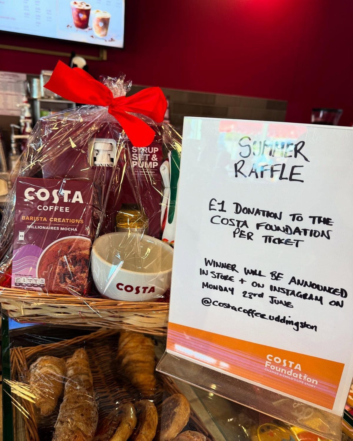 Costa Coffee raffle basket with a white mug and coffee products wrapped in cellophane.