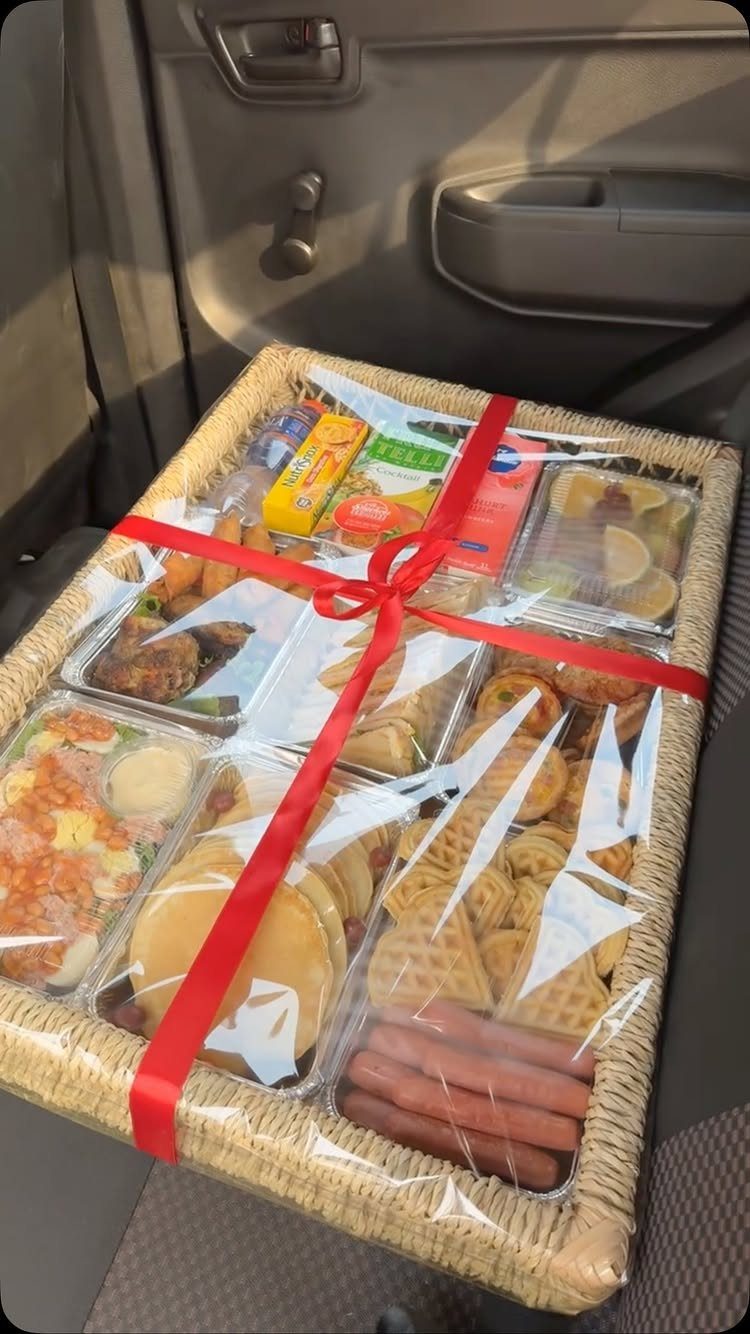 Breakfast themed raffle basket wrapped in cellophane with a red ribbon bow.