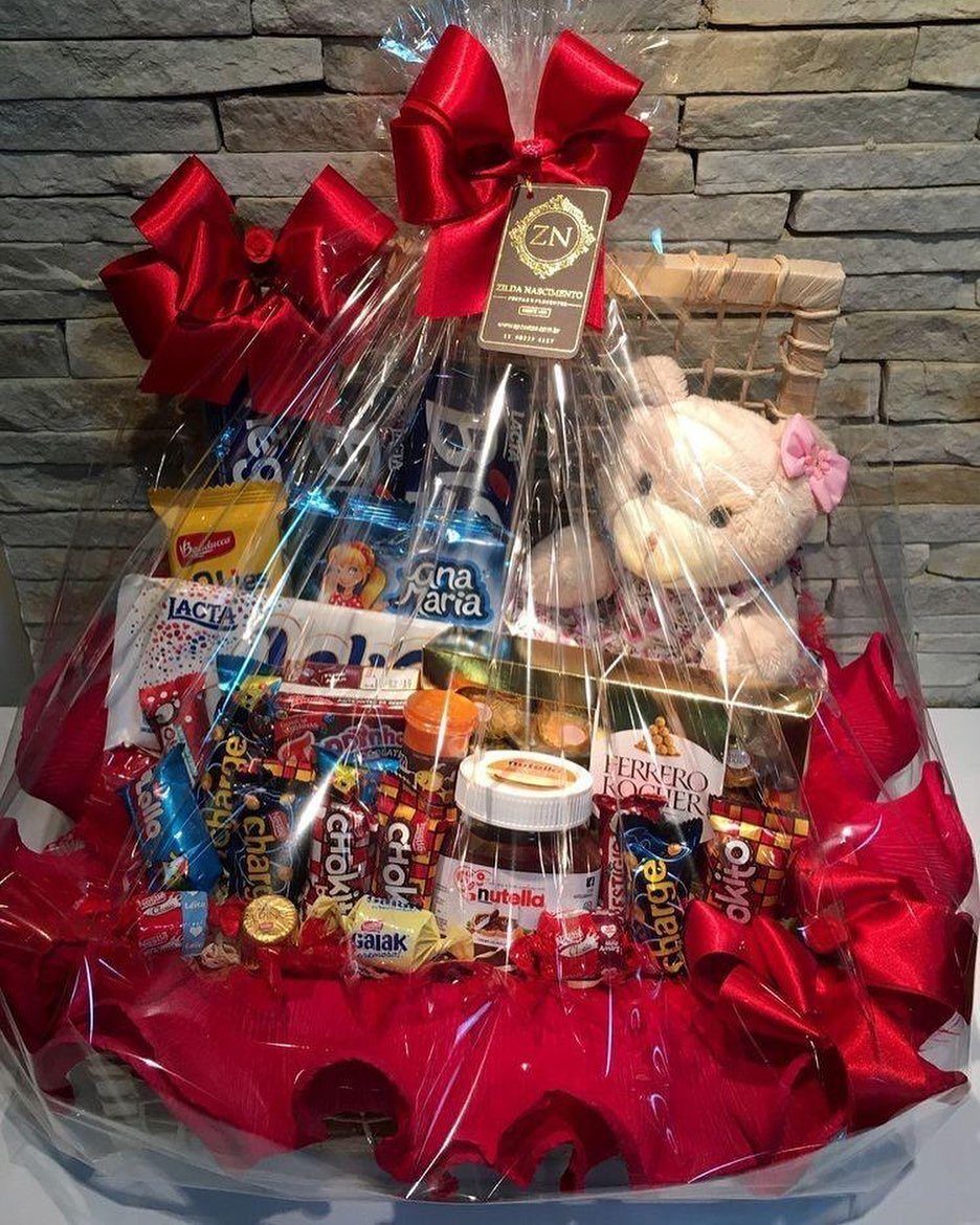 Chocolate gift basket with red bows, assorted candies, and a small teddy bear.