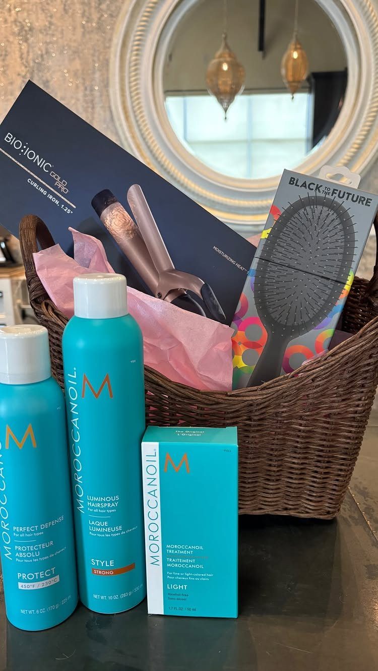 Hair care gift basket with turquoise Moroccanoil products and a curling iron box.