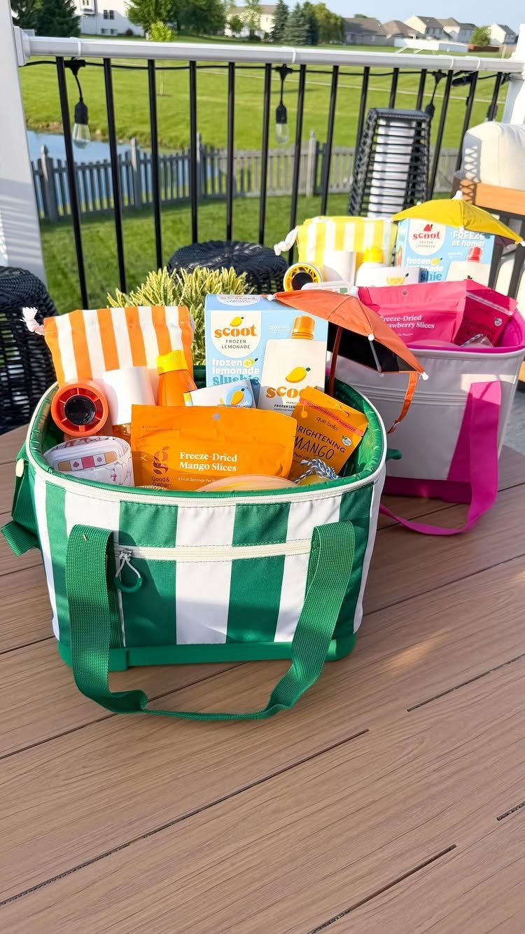Green striped fabric bin filled with summer snacks and beach accessories on a deck
