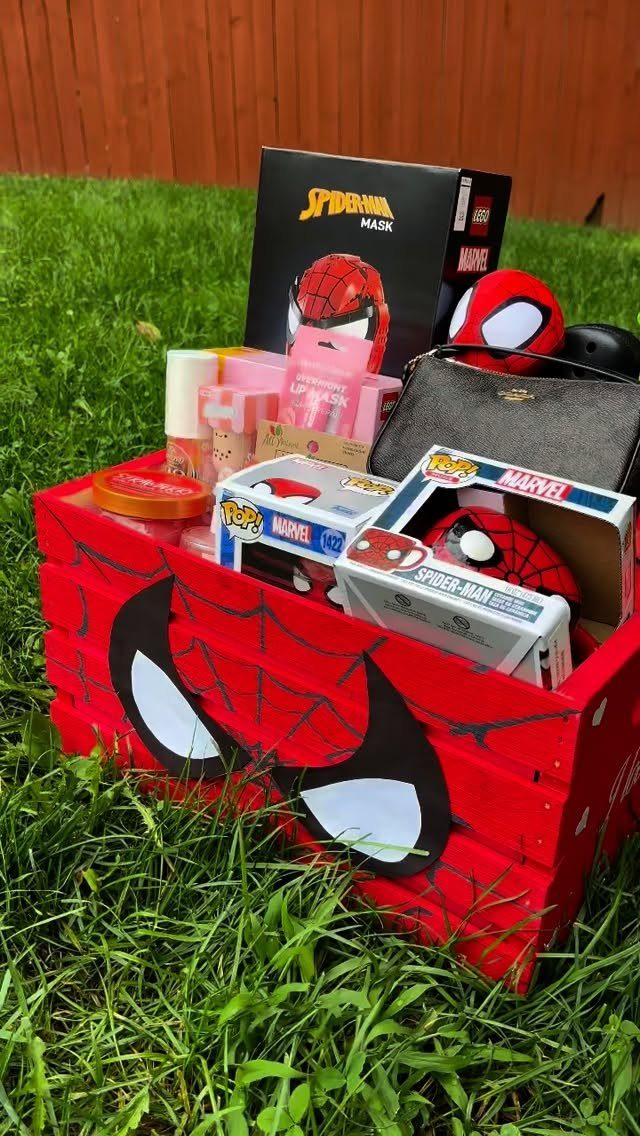 Spider-Man themed raffle basket filled with toys and accessories on green grass